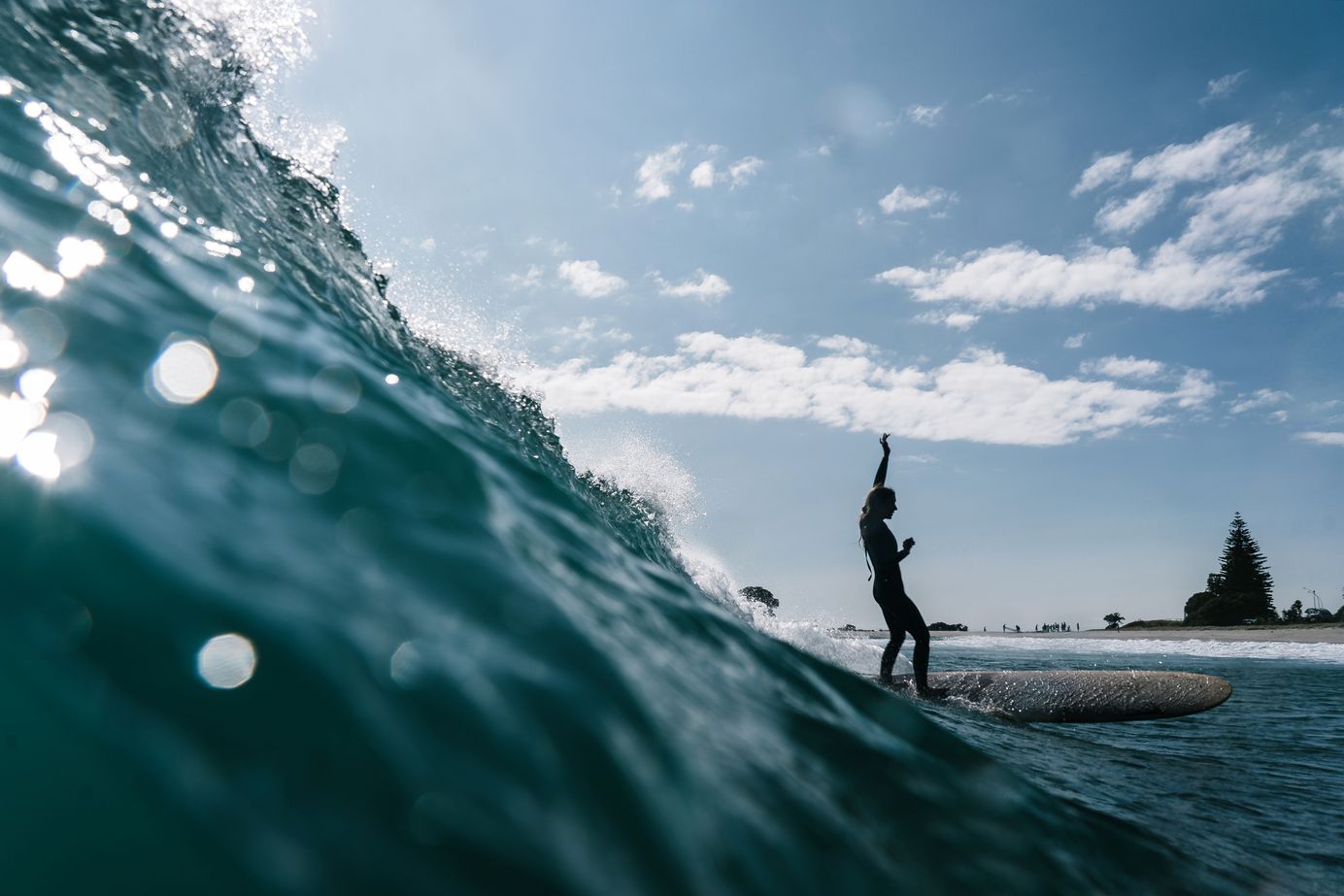 female surfer on a longboard in New Zealand